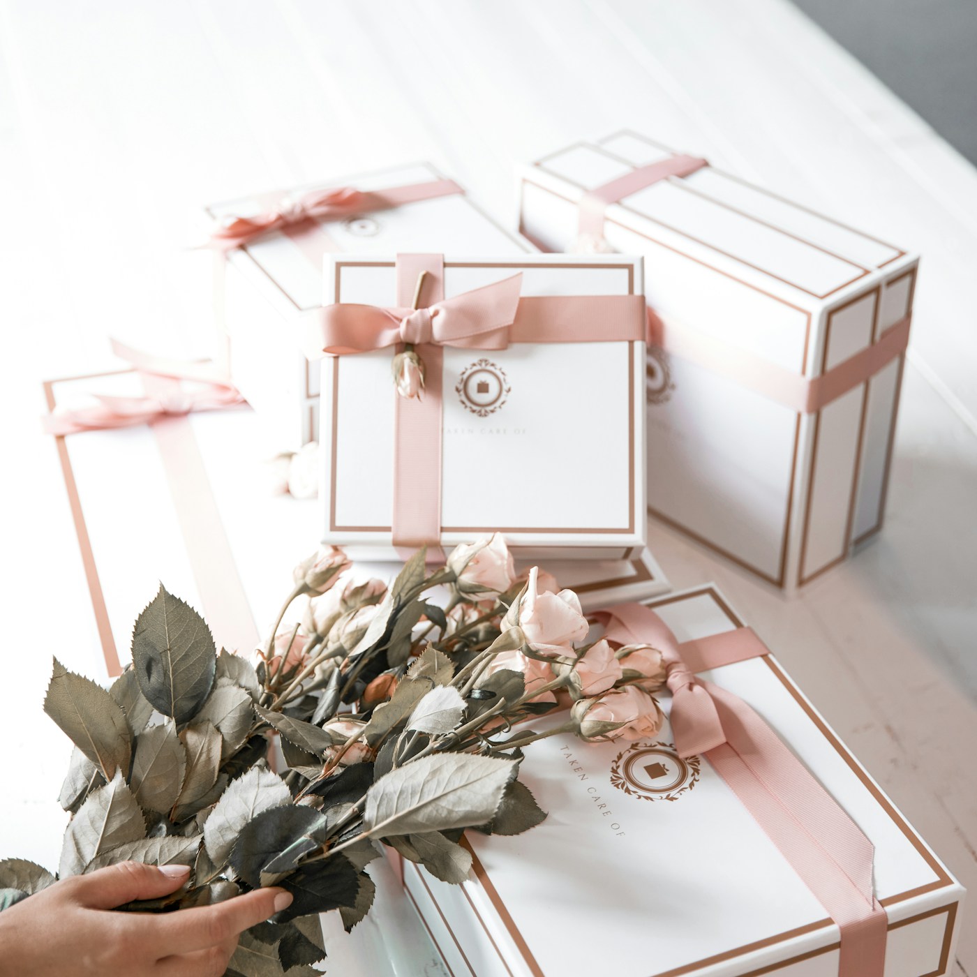 Beautifully wrapped gifts with soft pink ribbons and flowers